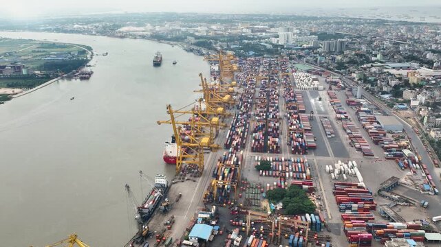 Chittagong, Bangladesh - 23 August 2025: Aerial view of Chittagong Port, a bustling hub of maritime activity, filled with cargo ships and stacks of containers.