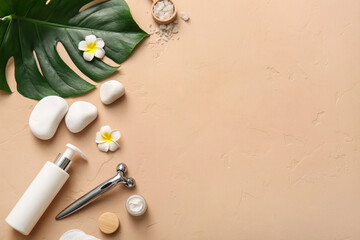 Spa composition with tropical leaf, stones, bottle and jar of cosmetic products on beige background, closeup