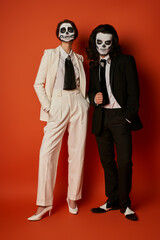 Couple honours Dia de los Muertos with sugar skull face paint and elegant outfits