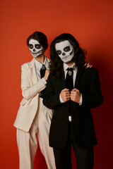 Couple celebrates heritage with sugar skull face paint for Dia de los Muertos festivities