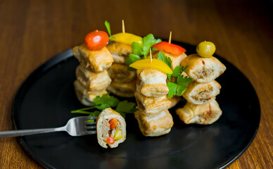 Close up of Party, Fun and Festive Mini Sausage Rolls Bites with Bell Pepper, Tomato, Traditional British English Finger Share Snack