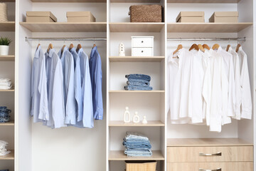 Wardrobe with shelves and clothes in dressing room