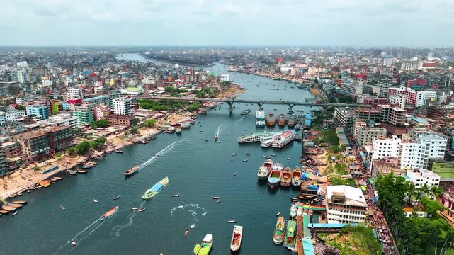 Dhaka, Bangladesh - 23 August 2025: Aerial view of a bustling river scene with boats, ships, and buildings creating a vibrant tableau of urban life.