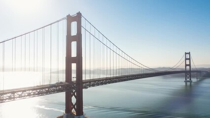 Aerial view of a iconic bridge over calm waters under a clear sky. - Powered by Adobe