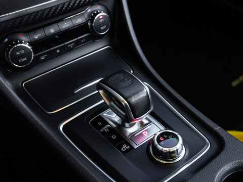 AMG gear selector with Affalterbach crest on a Mercedes A45, Interior of a high-performance german car.

