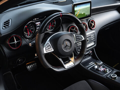 Cockpit of a Mercedes A45 AMG with a performance steering wheel, Interior of a luxury german hot hatch.

