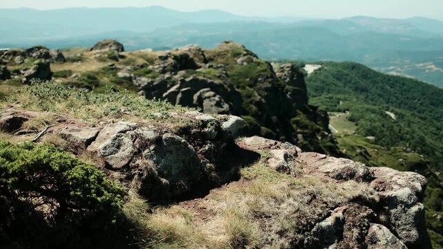 Rocky mountain slope with grass and vegetation under clear summer sky in Stara Planina National Park, Serbia. Planina Babin Zub
