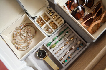 Organizers with stylish jewelry in wardrobe, closeup