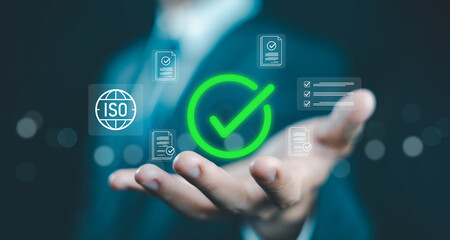 ISO certification concept with green checkmark icon floating above hand, symbolizing quality assurance, international standards, compliance, document approval, audit, and process validation.