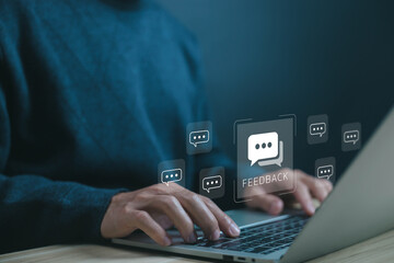 Customer feedback concept. digital chat bubble icons floating above a laptop, symbolizing online...