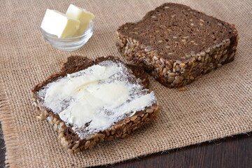 Bread with butter on burlap, food photography, healthy breakfast