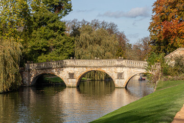 Cambridge, England. Clare Bridge, the oldest surviving bridge over the River Cam built in 1640, with autumn foliage and reflections on the water near King's College gardens