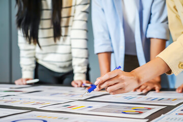 Close up hands of asian young business professionals engage in a dynamic brainstorming session....