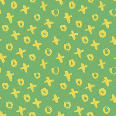 Seamless yellow pattern X and dots with green background