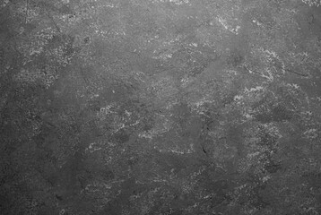 Dark gray wall with grunge texture and detailed plaster surface