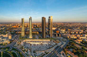 Aerial view of the Cuatro Torres Business Area skyscrapers in Madrid, Spain, at sunset