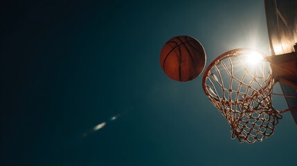 The basketball is about to go through the net, captured in a dynamic shot.