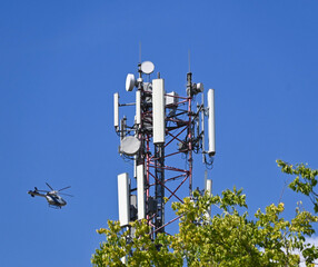 Mobil antenna tower and a helicopter in the background