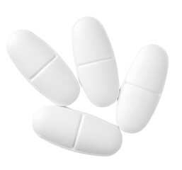 White oval pills isolated on white background, top view.