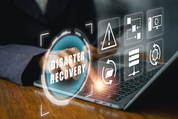 Futuristic digital interface illustrating disaster recovery with technology icons on a laptop...