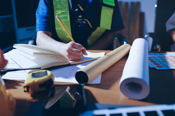 Closeup of team of industrial engineers meeting analyze machinery blueprints consult project on...