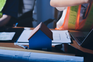 Closeup of team of industrial engineers meeting analyze machinery blueprints consult project on table in manufacturing factory. Working in manufacturing plant or production plant.