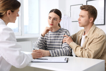 In vitro fertilization (IVF). Doctor supporting upset couple during visit in reproductive clinic