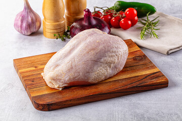 Raw chicken breast with bone and skin