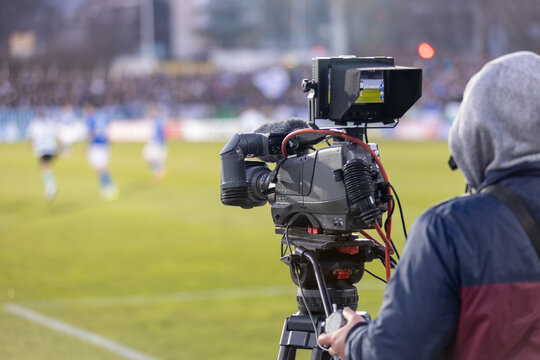 TV camera at the stadium, broadcasting during a football, soccer match. Behind the scenes of media coverage.