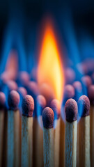 Close up of matchsticks with one ignited, surrounded by vibrant blue flame, creating striking contrast. image captures intensity and warmth of fire, highlighting texture of match heads