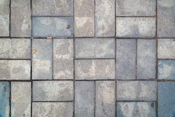 A textured gray paving stone pattern makes a versatile backdrop. Irregular shapes and slight color...