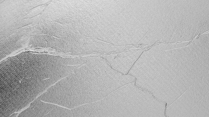 White plaster wall texture with subtle cracks and rough surface, minimal elegant background for...