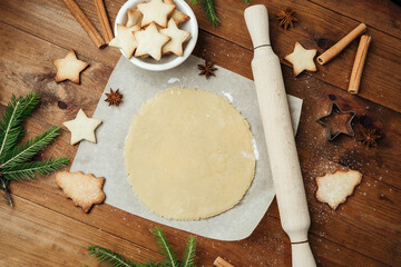 Festive cookie dough and baking setup on wooden table for christmas culinary and rustic food concept