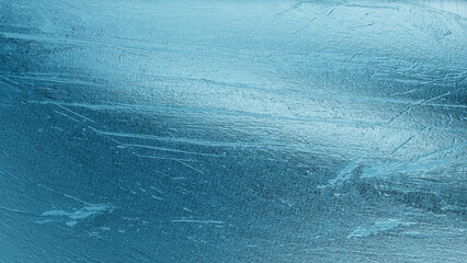 Abstract close-up of metallic blue foil texture with reflective details and smooth gradient tones,...