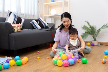An Asian mother and son do activities together at home, such as dressing up, playing games, playing ball, and drawing.