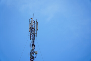 An upwards shot captures a telecom tower against a bright blue sky, ideal for showcasing connectivity and infrastructure. The tower represents communication networks and technological advancement.