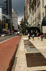 NYC New York City - Bikers Navigating Protected Lane in Bustling Downtown Traffic
