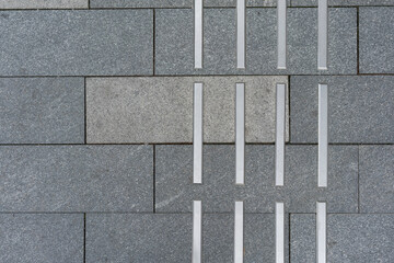 Sidewalk markings for blind people on gray pavement, close up