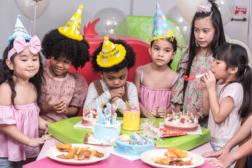 Group of  happy and enjoy kids have fun celebrating her birthday with Multinational friend kids birthday celebratiion party.