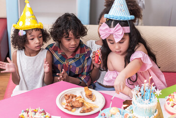 Group of  happy and enjoy kids have fun celebrating her birthday with Multinational friend kids birthday celebratiion party.