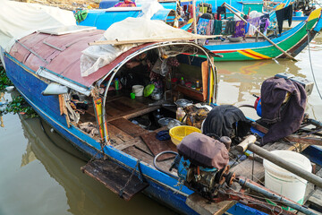 A vibrant composition featuring a collection of traditional boats along a serene waterway. The...