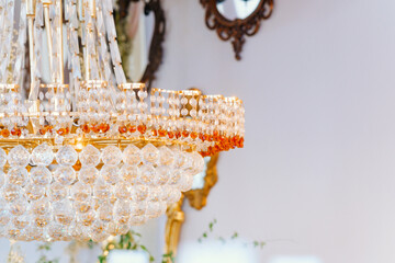 Elegant crystal chandelier with intricate design and warm vintage lighting