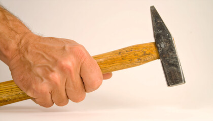 Close-up of a Man's Hand Holding a Claw Hammer, Ready to Strike