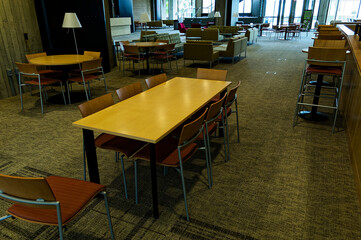 Modern Cafeteria With Wooden Tables In Sunlit Dining Area