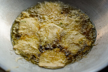 Aromatic delights sizzle in hot oil, creating a symphony of flavor and texture. A culinary masterpiece emerges from the depths, golden and crisp, ready to tantalize taste buds and elevate any meal.