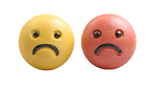 Two sad emoticon spheres yellow and red