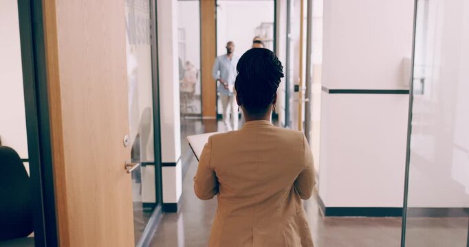 Walking, office and back of business woman with documents, paperwork and file for project. Corporate, workplace and person in morning for professional career, job and work and greeting coworkers