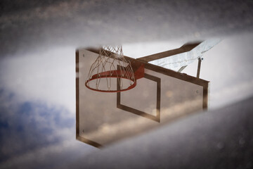 A basketball hoop reflected in a puddle after the rain © Giuseppe Cammino