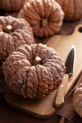 Black Futsu Pumpkins on Wooden Cutting Board