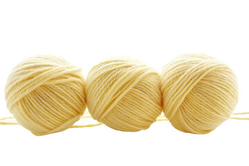 Three pale yellow yarn balls for knitting or crochet